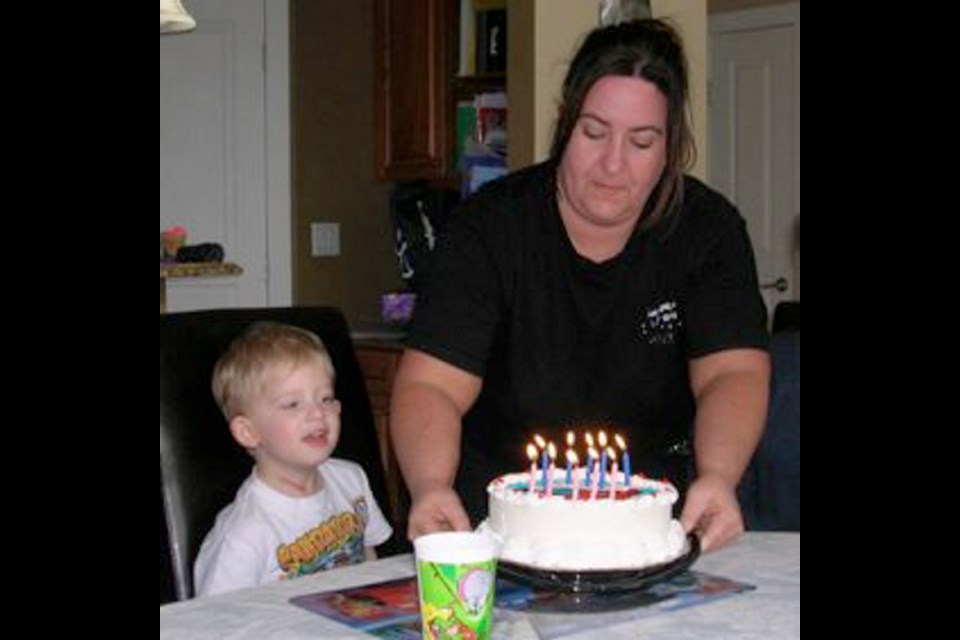 Kirsten Fowler delivers a cake to nephew Joshua on his fifth birthday, 2 1/2 months after his heart transplant.