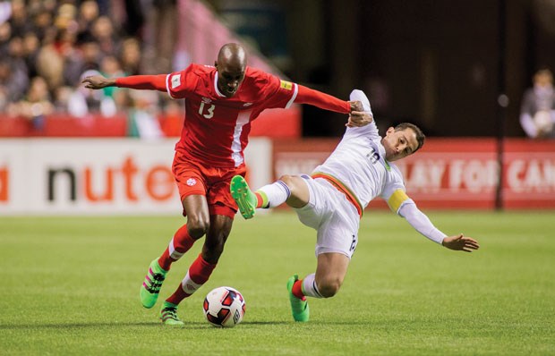 Canada’s Atiba Hutchinson jousts with Mexico’s Jesus Corona during a World Cup qualifier Friday at BC Place. A record-setting crowd was on hand to see Mexico score a 3-0 win.