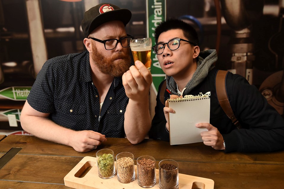 Brewmaster Caleb Colten (left), who is heading up the VSB’s Craft Fermentation Sciences pilot program, gives prospective student Kennedy Yeung a lesson in brewing techniques. Photo Dan Toulgoet