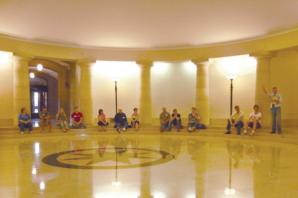 On his Hermetic Code Tour of the Manitoba Legislative Building, Frank Albo (with raised arm) explains the structure's many hidden symbols.