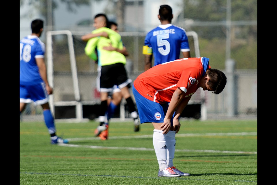 An Estrella de Chile FC Burnaby player hangs his head after Guildford FC scored the game-winning goal in the U21 Cup final last week at the Burnaby Lake West turf.