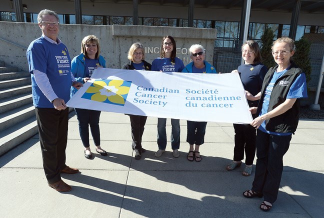 Mayor Lyn Hall along with left to right Aimee Cassie, Nancy Shelford, Megan Klitch, Helen Owen, Jana Peters and Margaret Jones-Bricker get ready to raise the Canadian Cancer Society flag at City Hall Friday. The mayor also proclaimed April as Daffodil Month. During Daffodil Month, the society is asking all Canadians to buy a daffodil pin and wear it to show their support for those living with cancer. Citizen photo by Brent Braaten April 1 2016