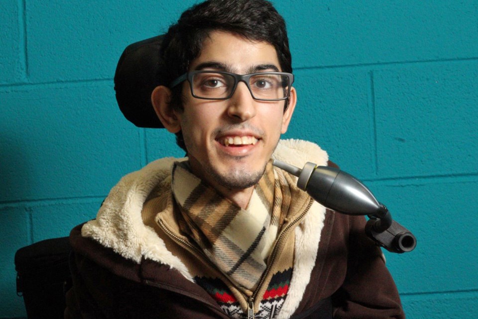 Milad Hajihassan, a North Shore resident who works at BCIT in Burnaby, poses with the LipSync, a mouth-controlled input device developed by the Neil Squire Society to enable people with little or no hand movement to operate a touchscreen device.