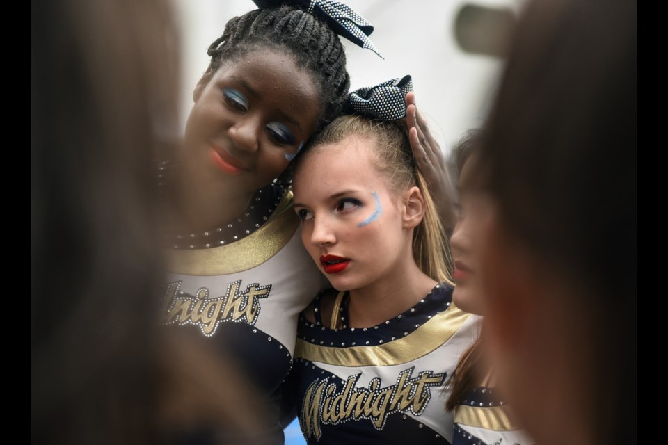 Athletes from Vancouver’s Midnight Cheer Athletics club shared a moment prior to competing in the senior level 1 division during Saturday’s portion of the 10th annual Sea to Sky International Cheerleading Championships at the Vancouver Convention Centre Friday through Sunday. Photograph by: Rebecca Blissett