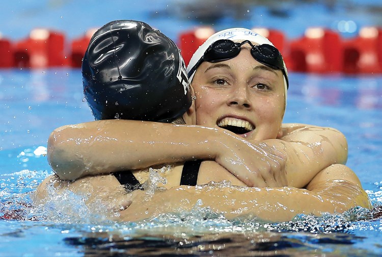 Emily Overholt hugs a fellow competitor at the Canadian Olympic and Paralympic Trials. Overholt will swim for Team Canada at the Olympic Games this summer in Rio.