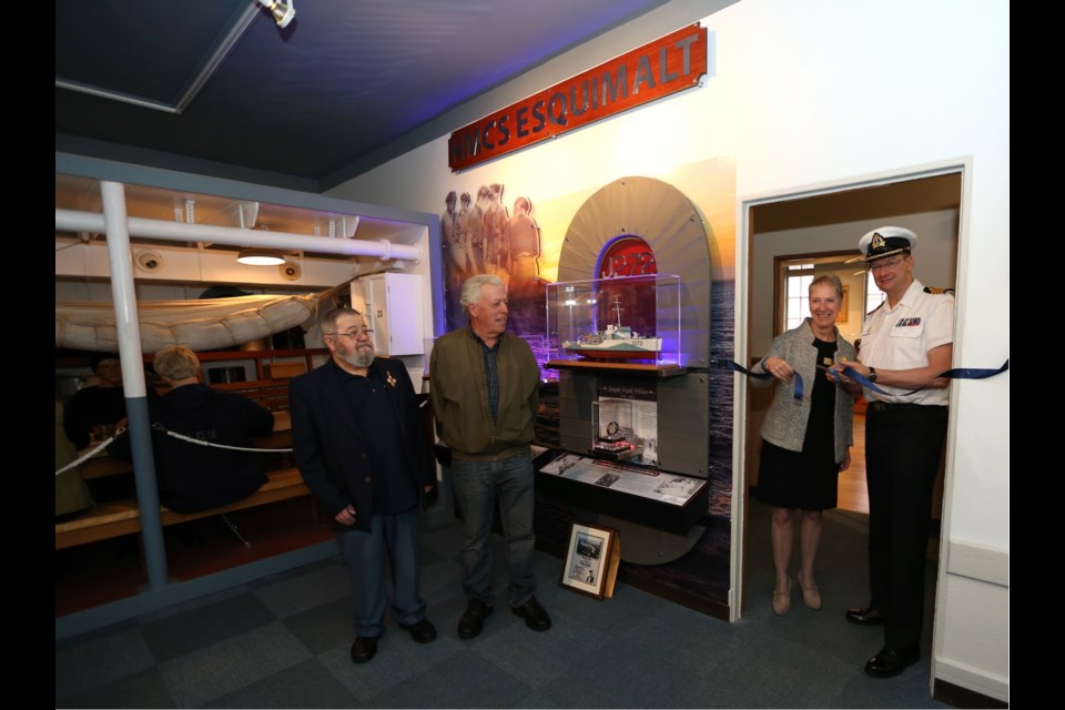 Esquimalt Mayor Barb Desjardins and Navy Capt. Steve Waddell, the base commander, cut the ribbon opening the exhibit, joined by family members of two survivors, Tom Goddard, left, and Ralph Zbarsky.