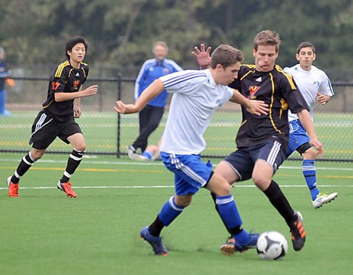 West Vancouver (black) and Handsworth battle it out for first place in the AAA soccer division in a game held at Ambleside.