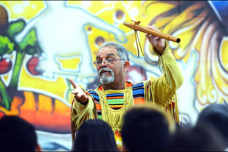 Indigenous storyteller and Surrey resident Old Hands tells students in the Burnaby North Secondary cafeteria a story about the origin of the Native American flute. The storyteller was at Burnaby North Monday as part of the school’s second annual Day of Truth and Reconciliation.