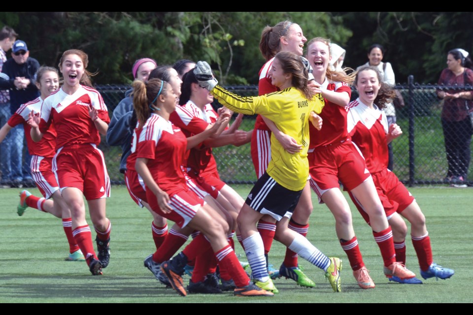 Richmond Ravens goalkeeper Ali Burns is mobbed by her teammates after making the clinching save in her team's 1-0 win in penalty kicks over Surrey in the Coastal Cup semi-finals.