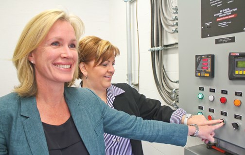 Former BC Hydro President Jessica McDonald (left) and Fort St. John Mayor Lori Ackerman punch the power on the city's micro-hydro station in April 2016. Officials estimate the station will generate between $75,000 to $80,000 a year for the city, helping to offset its cost of pumping Peace River water out of the valley to homes and businesses, the city's biggest electricity cost.