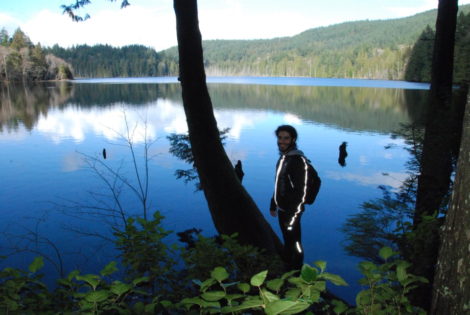 Hiker from France pauses by lake