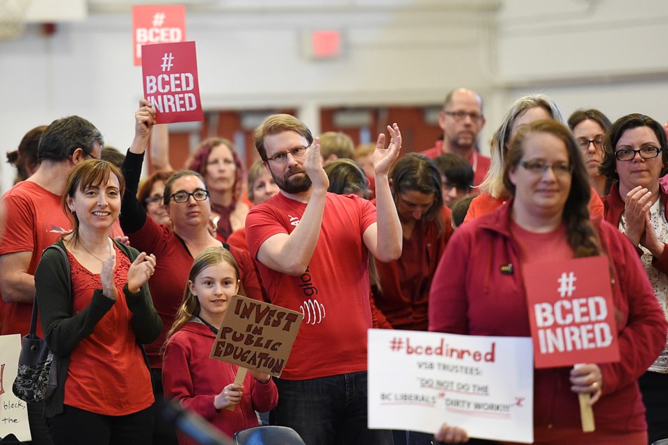 Many attending a school board budget meeting heeded the call to wear red clothing in solidarity with a “No Cuts” campaign, providing a striking visual for TV cameras and social media content. Photo Dan Toulgoet