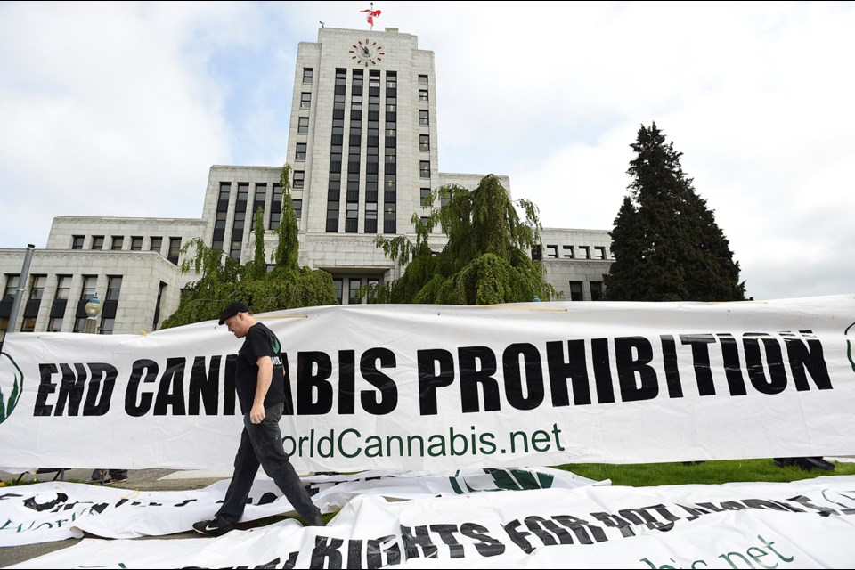 About 30 marijuana advocates turned up outside city hall Friday to protest the city's order for illegal pot shops to shut down April 29. Photo Dan Toulgoet