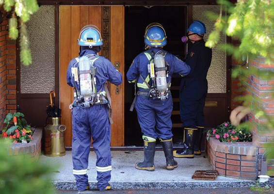 District of North Vancouver and RCMP fire investigators prepare to enter a home at 815 East 29th Street, North Vancouver Tuesday morning in the wake of a fire, believed to have been deliberately set Monday evening.