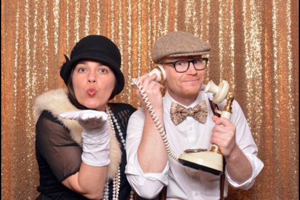 Lindsay Rehner and Derek Cruikshanks get in the mood for the Great Gatsby Gala. They are the owners of the Four Frames photo booth that will be at the gala taking vintage pictures.