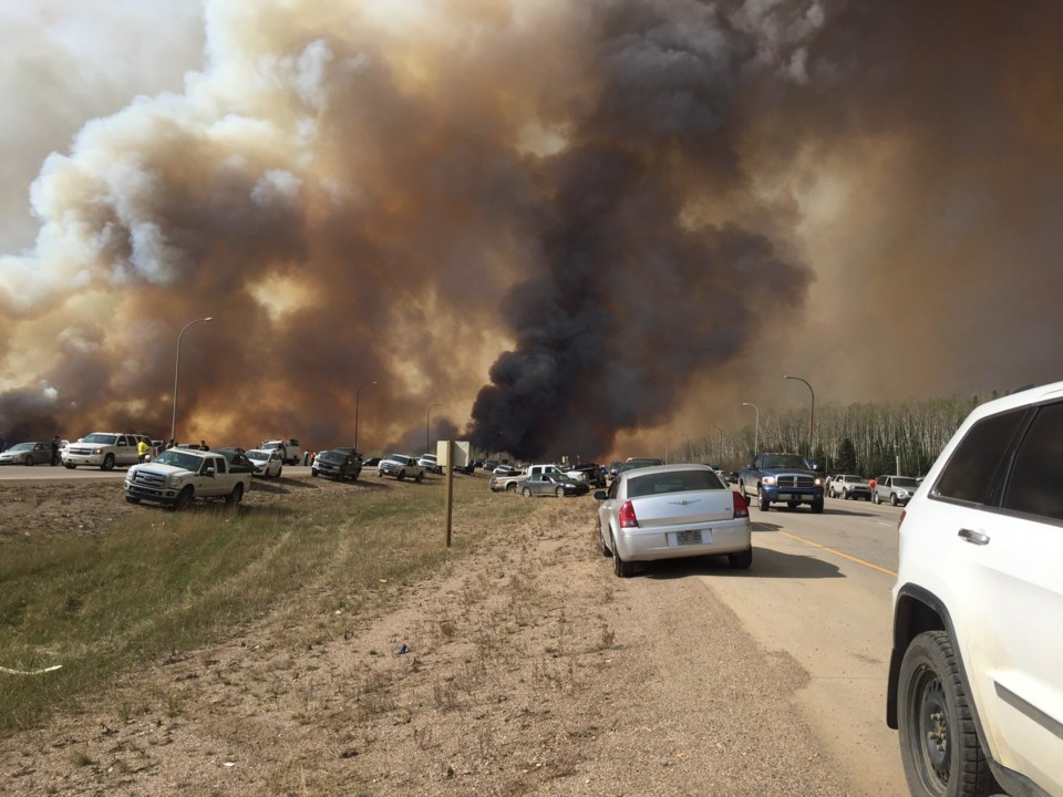 Abandoned vehicles litter Highway 63, south of Fort McMurray, Alta., as residents fled the wildfire