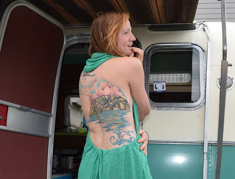 Liesl Petersen shows off her back tattoo in front of her Airstream home in downtown Squamish.
