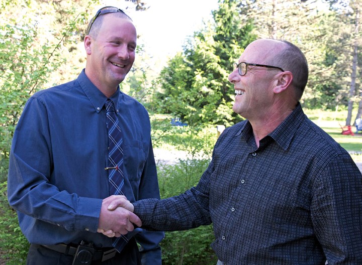 New Sechelt fire chief Trevor Pike (left) shakes hands with outgoing chief Bill Higgs.