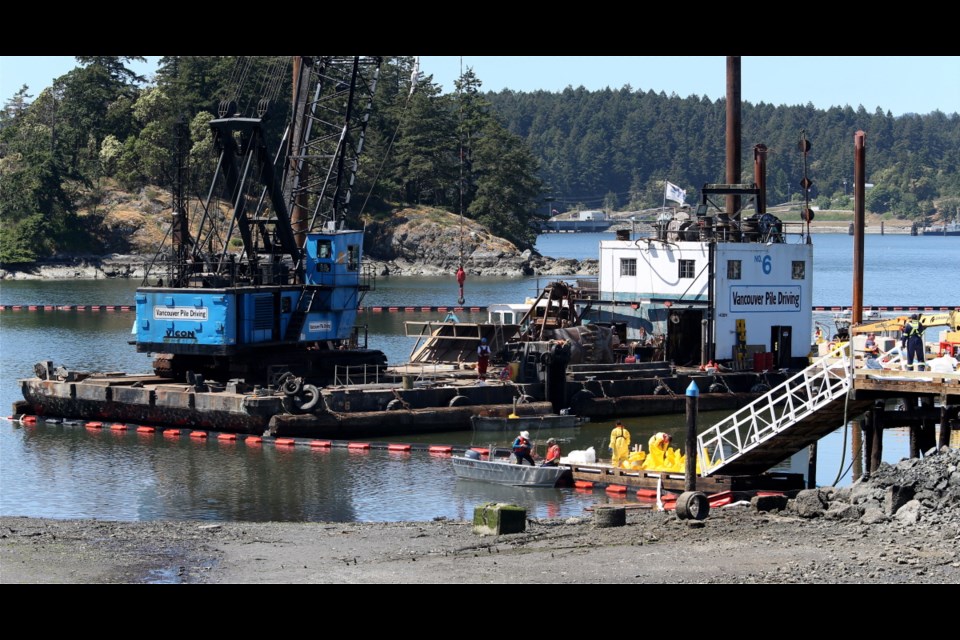 Cleanup work at Plumper Bay on May 9, a day after a barge ran aground and spilled diesel.