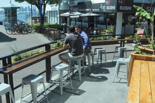 Martin Ebadi, owner of Green Leaf Brewing in the Lonsdale Quay Market, chats with a patron on his craft brewery's enviable patio. The brewery has added a new flavour to the bustling Quay. photo by Mike Wakefield, North Shore News
