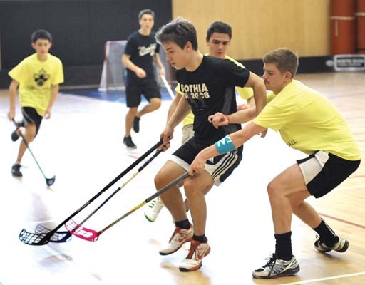 Handsworth's Jakob Brandstrom (yellow) and Sentinel's Jamie Turner (black) compete at Sutherland Secondary in the first ever high school floorball tournament.