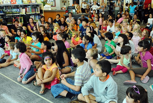 The crowd settles in to watch magician Tricky Ricky take the stage.