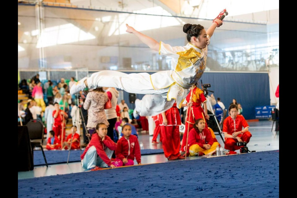 Bianca Go soars over the mat during her winning Wushu performance at the 37th annual Can Am Martial Arts Championships on the weekend at the Richmond Olympic Oval.