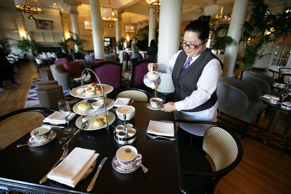 Madeline Young sets up a tea service in the renovated Tea Lobby at the Fairmont Empress hotel.