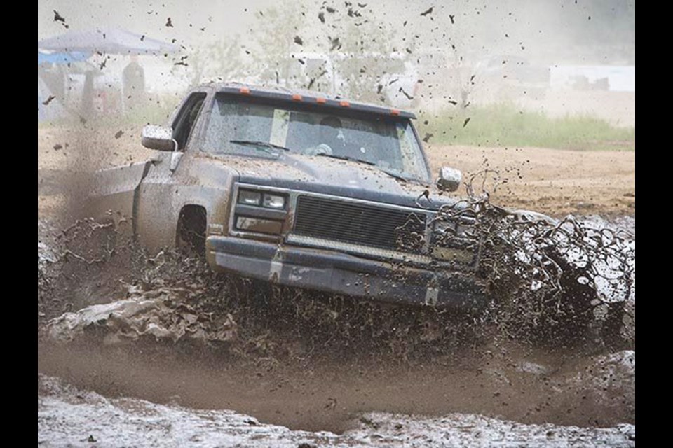 A truck motors through the mudflats at Stave Lake near Mission, on Sunday, May 8, or "Mudders Day."