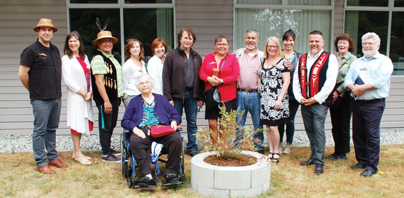 Celebrants from Capilano University and shíshálh Nation pose for a group shot outside the Sechelt campus where a kàlax-ay plant grows in honour of the building’s new name. See more photos in our online galleries.