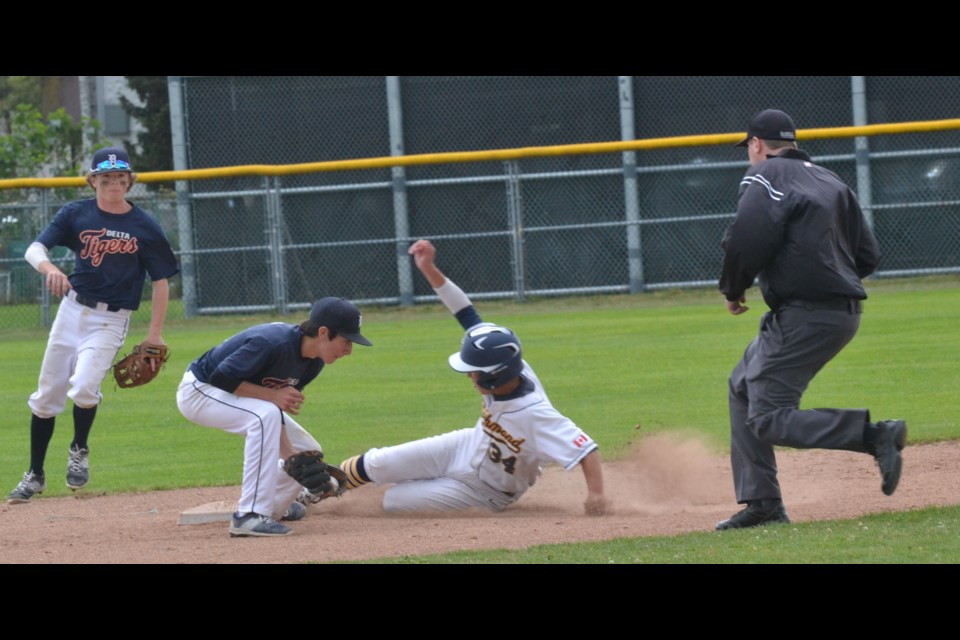 Richmond Chuckers' Dustin McElwain safely reaches second base during action from Monday's championship game.