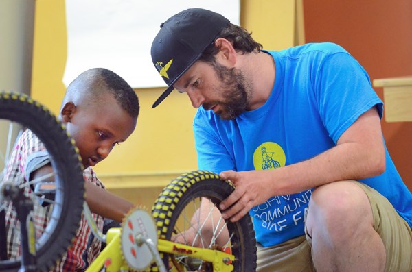 Jeff Bryson, owner of The Bikeroom in North Vancouver, helps Grade 5 student Abdi Ahmed Mohamed work on a donated bike during an after-school program at Edmonds Community School that teaches kids how to fix and maintain bicycles.