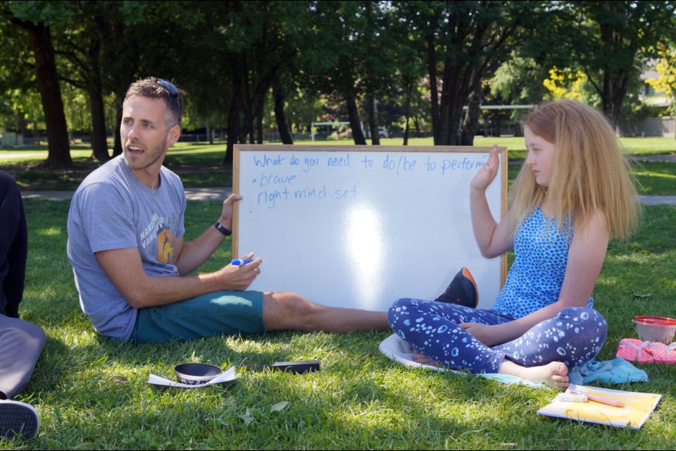 General Currie elementary teacher James Thesiger jots down all the great ideas from his students, including Elise Charpentier, right.