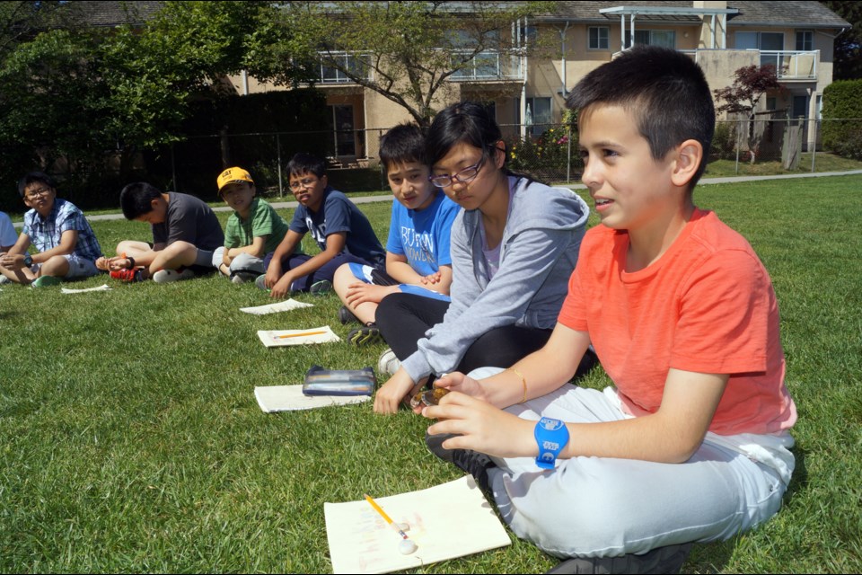 Students at General Currie elementary school participate in an outdoor circle to share ideas on various subjects and to "check-in" as to how they are doing. May 2016.