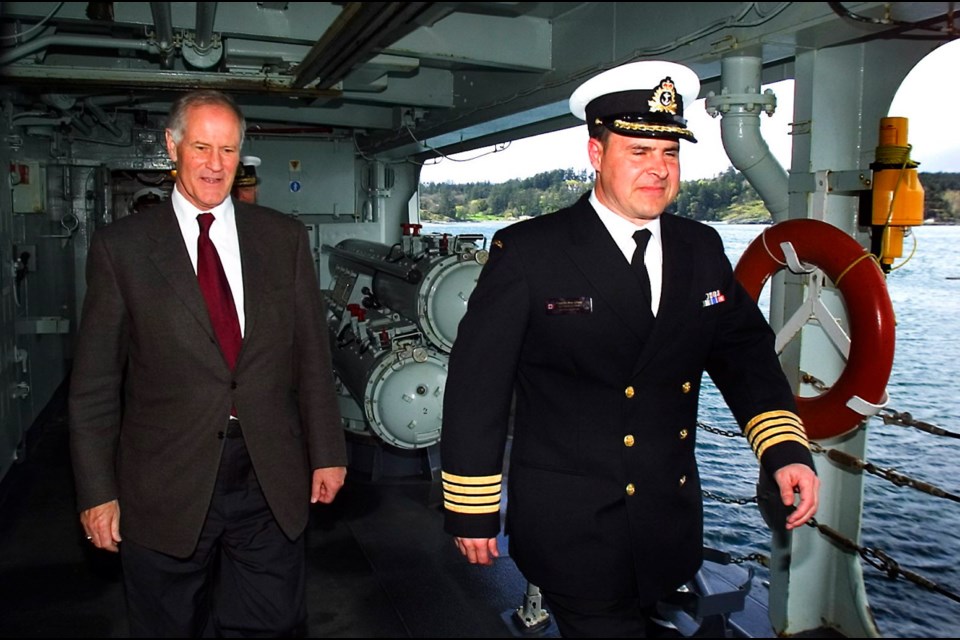 Then-defence minister Bill Graham, left, and Capt. Ron Lloyd disembark HMCS Algonquin in 2005.