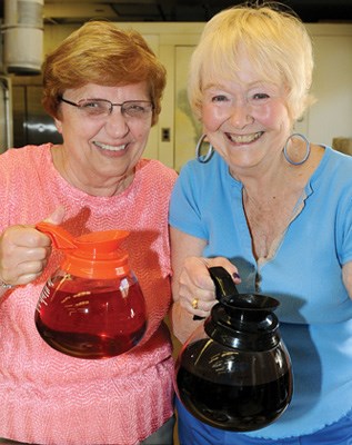 Betty Lebeter and Kathleen Spencer serve coffee and tea.