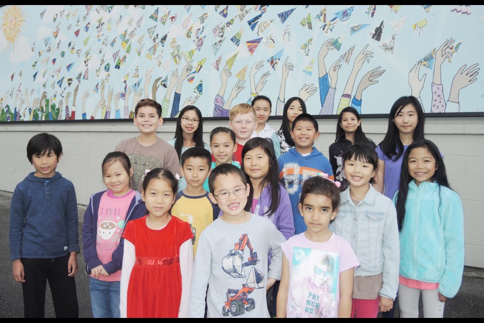 Just a few of the Blair elementary kids show off their mural, which every one of the 352 students quite literally had a hand in.