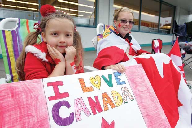 Six year-old Madelyne Honcharuk and her brother William, 13, wait patiently on 13th Street for the parade to start.