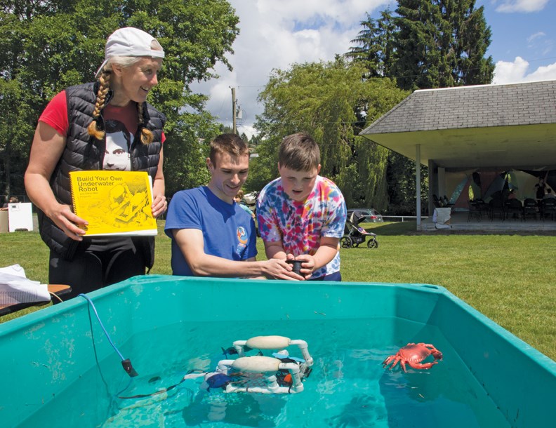 Lee Ann Ennis and Cameron Anderson show Ryan Wannamaker the marine ROV built by the Pender Harbour Secondary science and technology class and the Ruby Lake Lagoon Society, at the Mini Maker Faire on May 29. See more photos in our online gallery.