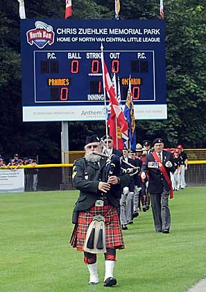 Piper Milt Cameron leads in the honour guard and players at the opening ceremony of the 2011 Little League National Championships.