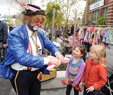 Whistles the Clown makes balloon animals at the Ridgeway Elementary School in North Vancouver as it celebrated it's 100th birthday with a community party.