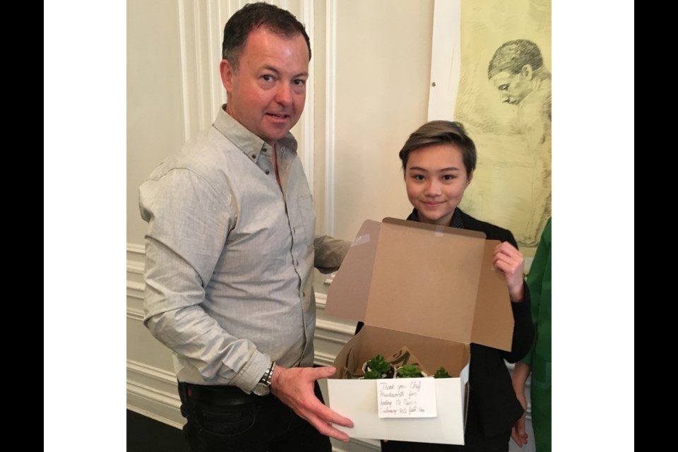 McNair secondary Grade 10 student AJ Rocha, who’s in the school’s culinary arts program, presents some succulent chocolate cupcakes to chef David Hawksworth, during a class visit to his acclaimed self-named restaurant in downtown Vancouver. Photo submitted