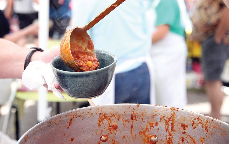 Chili gets ladled into a bowl on Saturday at the Community Arts Council's Spring Arts Bazaar and the Prince George Potters Guild's 41st Annual Great Northern Chili Cookoff at Studio 2880. Twelve teams competed in the chili cook off with MLA Shirley Bond, and MLA Mike Morris looking to hold on to their title as defending champs. Citizen Photo by James Doyle June 4, 2016