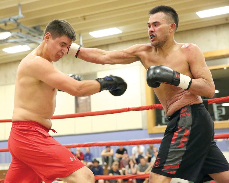 Lyndon Creyke (black trunks) lands a punch to the face of George Spalding (red trunks) on Saturday during the main event of the Real Fights boxing card that took place at College of New Caledonia. Citizen Photo by James Doyle June 4, 2016