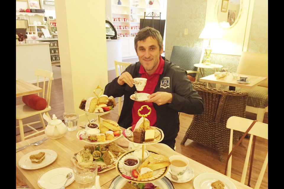 News reporter Alan Campbell flips the pinky at the Venus Sophia tea room in Victoria’s historic Chinatown. It was Campbell’s first attempt at an official afternoon tea.