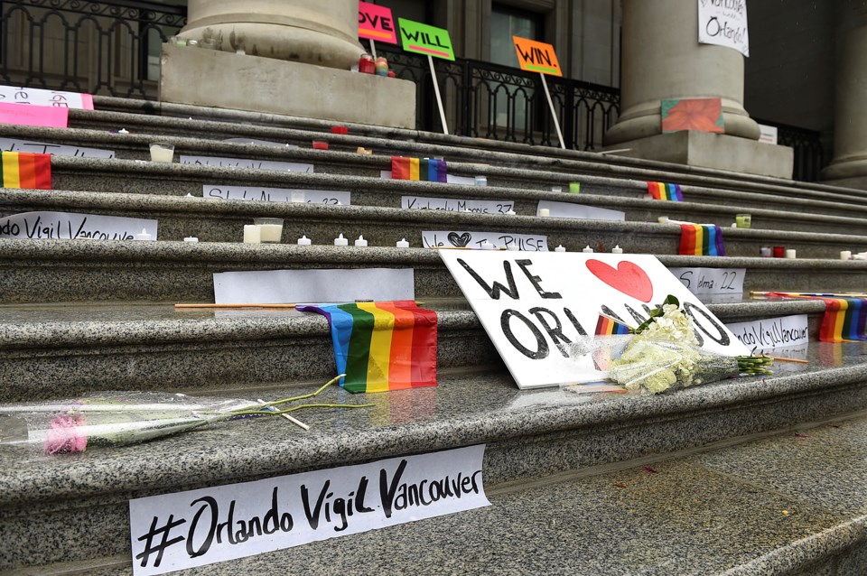 Vancouver residents mourned those murdered in Orlando at a vigil Sunday night. Photo Dan Toulgoet