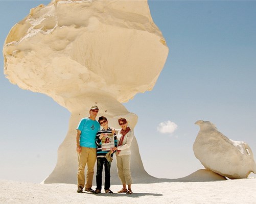 Michael Sharp, Alex Sharp and Caroline Helbig stop in the shade of an amazing rock formation in Egypt's White Desert.