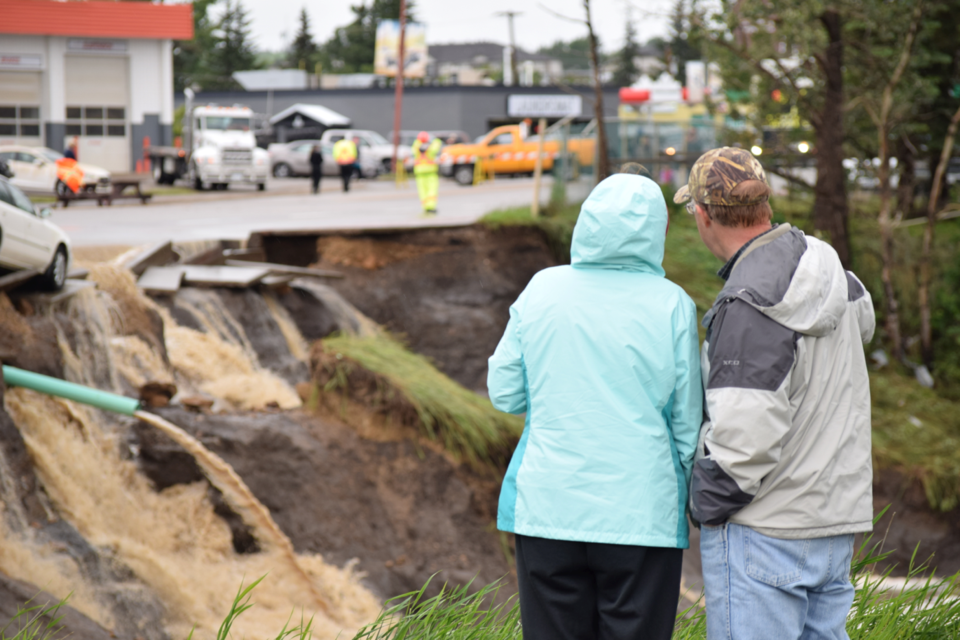 Hundreds turned out to watch as Dawson Creek tore apart 8th Street Thursday. 10 centimetres of rain overwhelmed the city's sewage system, washing out or destroying bridges across town.