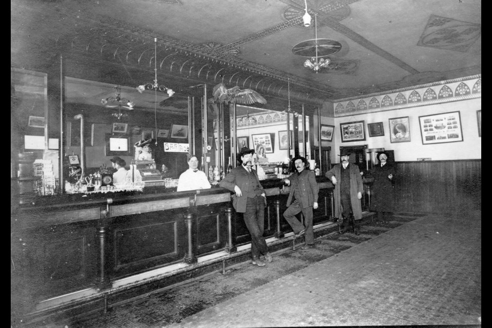 Patrons belly up to the bar at the Fraser Hotel at the corner of Front and Begbie streets, circa 1900.