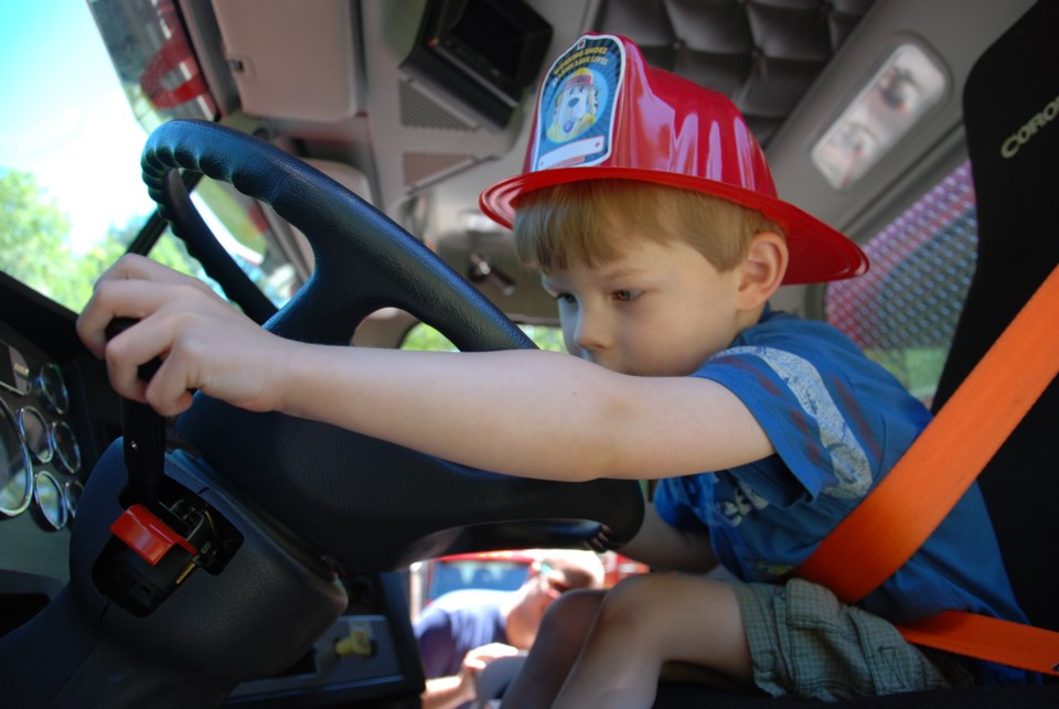 What could be more fun for a little boy than putting on a firefighter’s helmet and climbing into a f